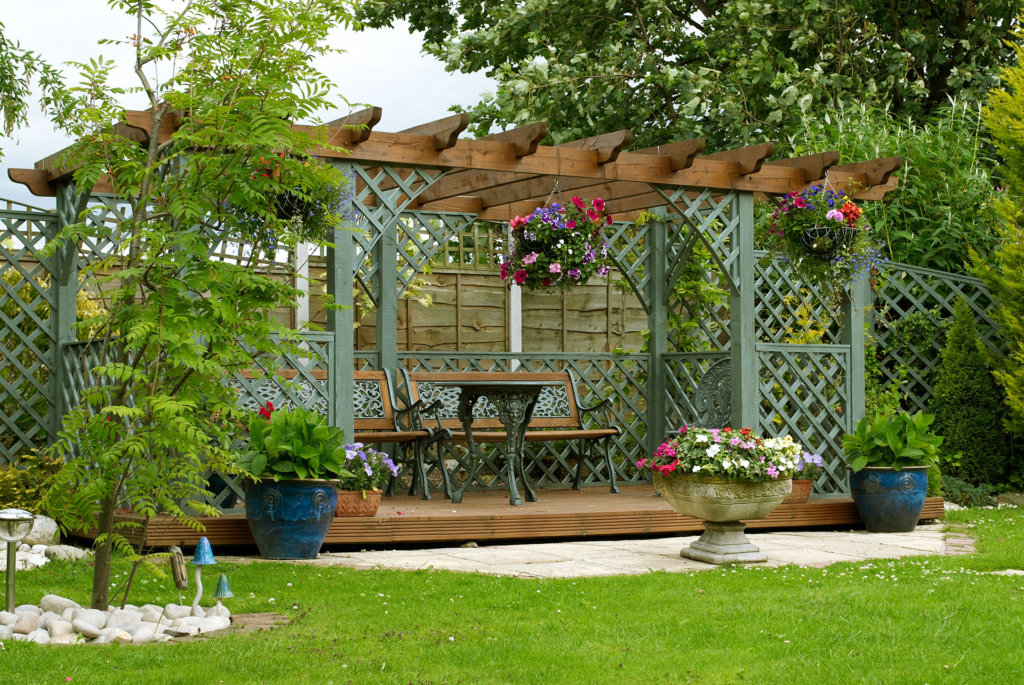 Front view of a decorative pergola in an English urban garden